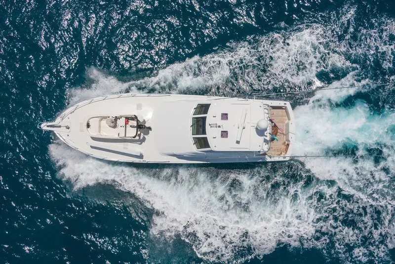 Slide: The Image of Aerial view of 2005 Hatteras Enclosed Bridge yacht cruising through ocean waves. - 4