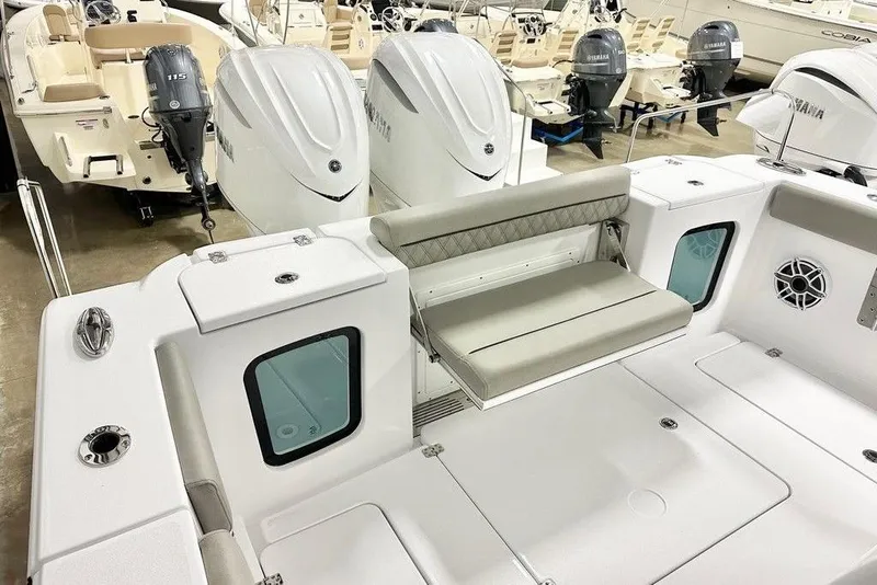 Slide: The Image of 2025 Sportsman Open 302 boat interior with seating and Yamaha outboard motors. - 11
