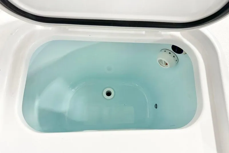 Slide: The Image of Livewell compartment in 2025 Sportsman Open 302 boat, filled with water. - 12
