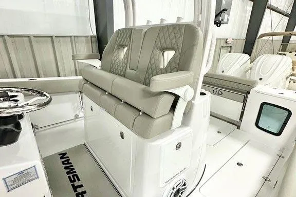 Slide: The Image of 2025 Sportsman Open 302 boat interior with cushioned seating and modern design. - 4