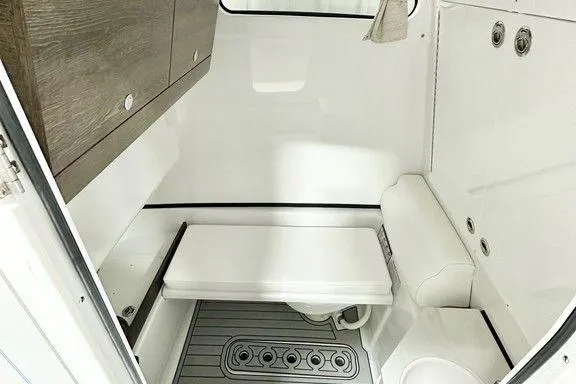 Slide: The Image of 2025 Sportsman Open 302 boat interior with modern white and wood finish. - 5