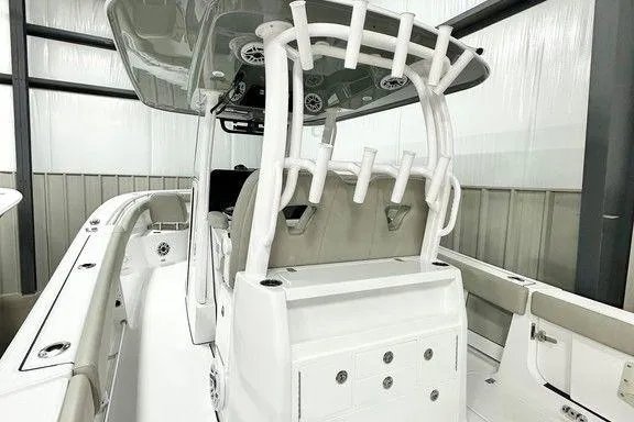 Slide: The Image of 2025 Sportsman Open 302 boat interior with rod holders and seating. - 6