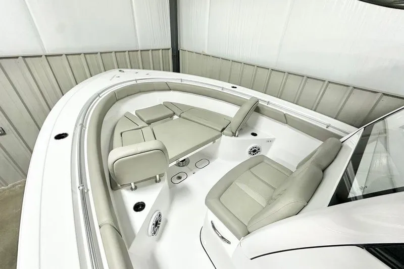 Slide: The Image of 2025 Sportsman Open 302 boat interior with cushioned seating and modern design. - 7