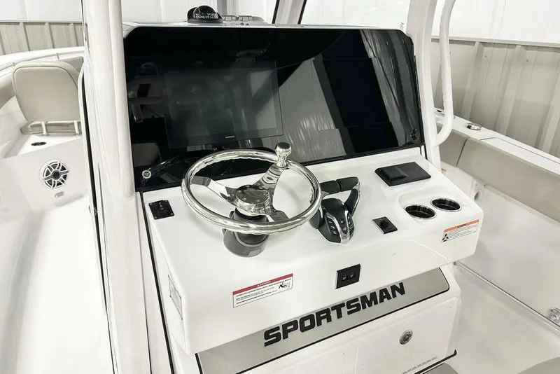 Slide: The Image of 2025 Sportsman Open 302 boat console with steering wheel and controls. - 9