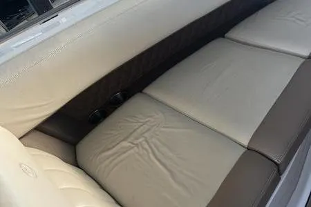 Slide: The Image of 2009 Cobalt 296 boat interior with beige and brown cushioned seating. - 4