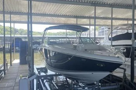 Slide: The Image of 2009 Cobalt 296 boat interior with beige and brown seating and teak flooring. - 7