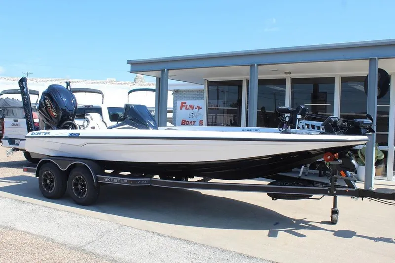 Slide: The Image of 2026 Skeeter ZXE20 boat on trailer, parked outside dealership. - 1