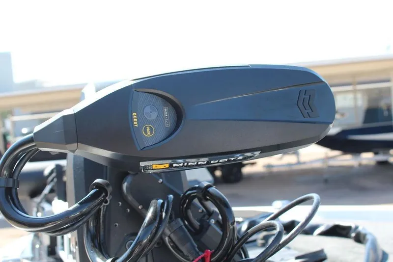 Slide: The Image of Close-up of a 2026 Skeeter ZXE20 boat motor with visible cables and controls. - 13