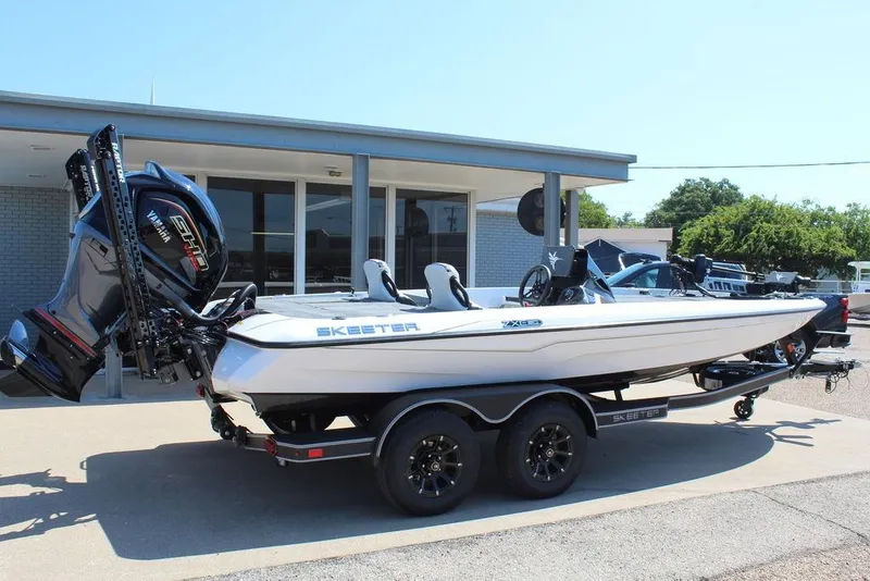 Slide: The Image of 2026 Skeeter ZXE20 boat on trailer, featuring Yamaha engine, parked outside a building. - 7