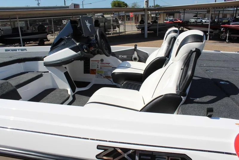 Slide: The Image of 2026 Skeeter ZXE20 boat interior with white seats and modern dashboard. - 9