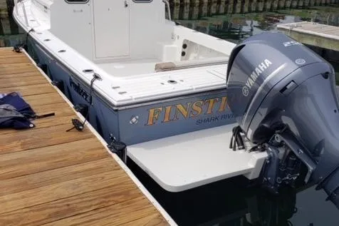 Slide: The Image of 2017 Parker 2320 SL Sport Cabin boat docked, featuring Yamaha outboard motor. - 4