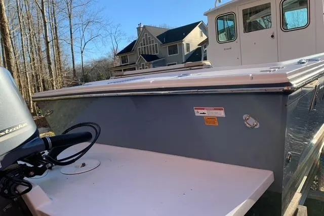 Slide: The Image of 2017 Parker 2320 SL Sport Cabin boat near residential homes and trees. - 6
