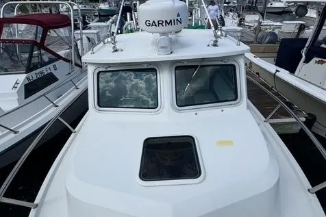 Slide: The Image of 2017 Parker 2320 SL Sport Cabin boat docked, featuring Garmin equipment. - 8