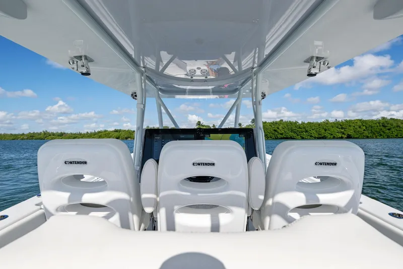 Slide: The Image of 2026 Contender 44 CB boat interior with white seating, navigating on calm waters. - 17