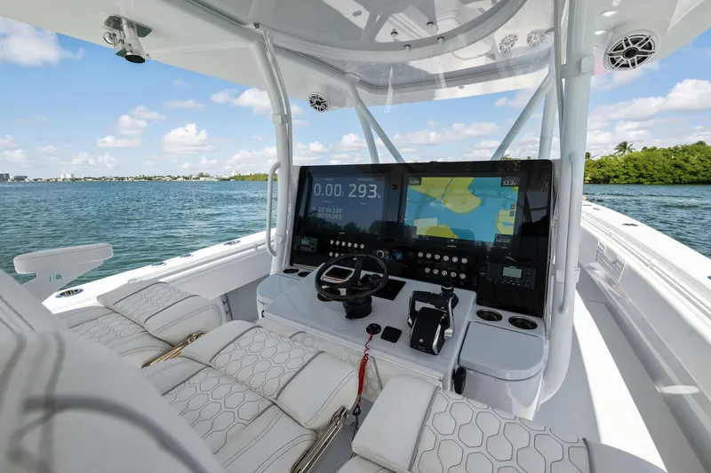 Slide: The Image of Helm of 2026 Contender 44 CB boat with advanced navigation system on open water. - 19