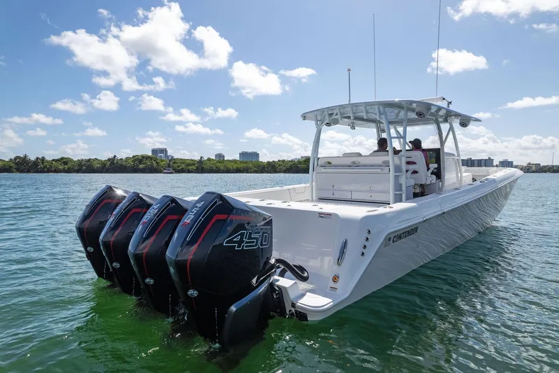 Slide: The Image of 2026 Contender 44 CB boat with quad 450 engines on a sunny day. - 20