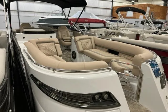 Slide: The Image of 2022 Crest Savannah 250 SLC pontoon boat with luxurious seating in showroom. - 0