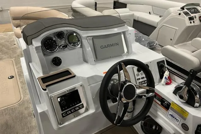 Slide: The Image of 2022 Crest Savannah 250 SLC boat dashboard with Garmin navigation and steering wheel. - 1