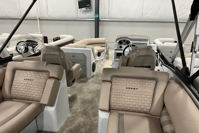Slide: The Image of 2022 Crest Savannah 250 SLC boat interior with luxurious seating and modern dashboard. - 6