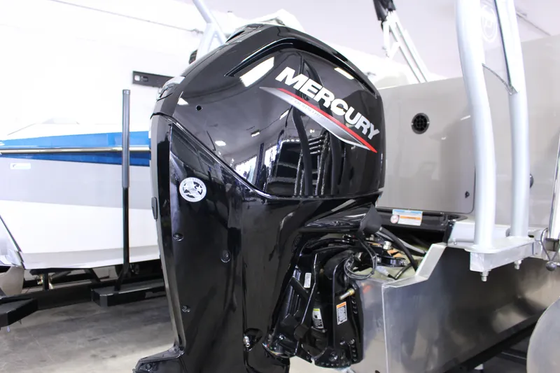 Slide: The Image of 2022 Premier 230 Explorer with Mercury outboard motor in showroom setting. - 11