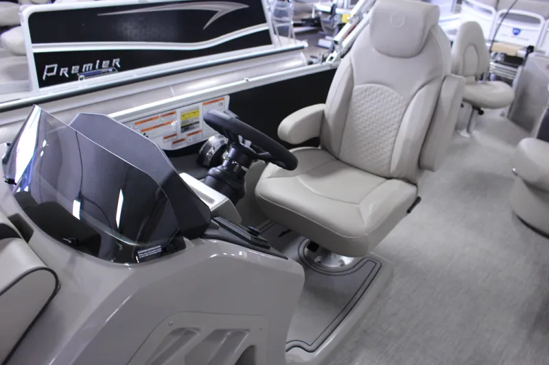 Slide: The Image of 2022 Premier 230 Explorer boat interior with steering console and comfortable seating. - 21