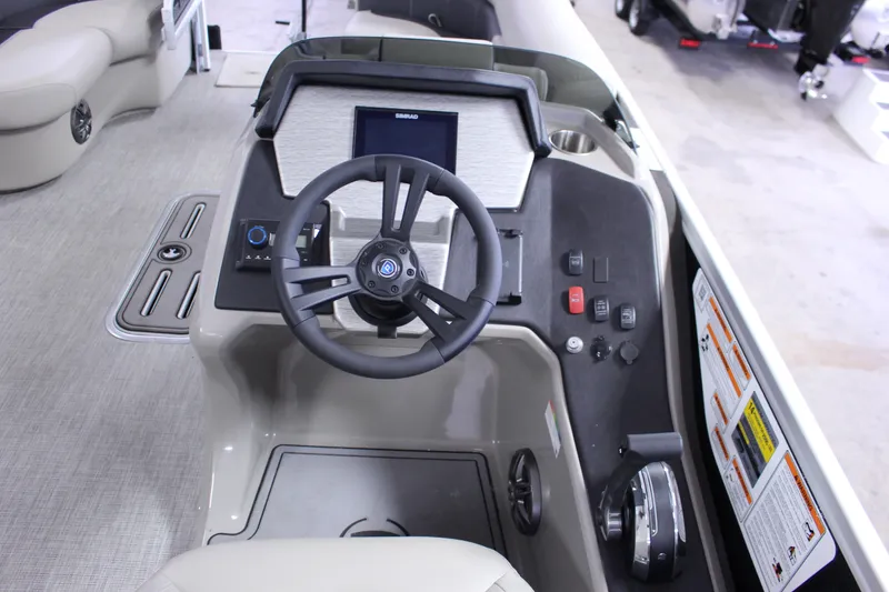 Slide: The Image of 2022 Premier 230 Explorer boat dashboard with steering wheel and control panel. - 24