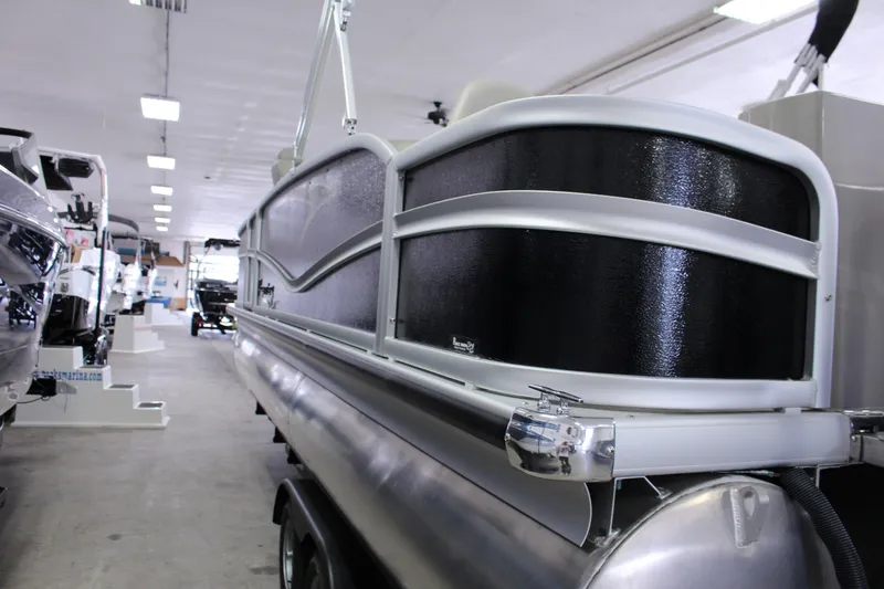 Slide: The Image of 2022 Premier 230 Explorer pontoon boat displayed in a showroom. - 8