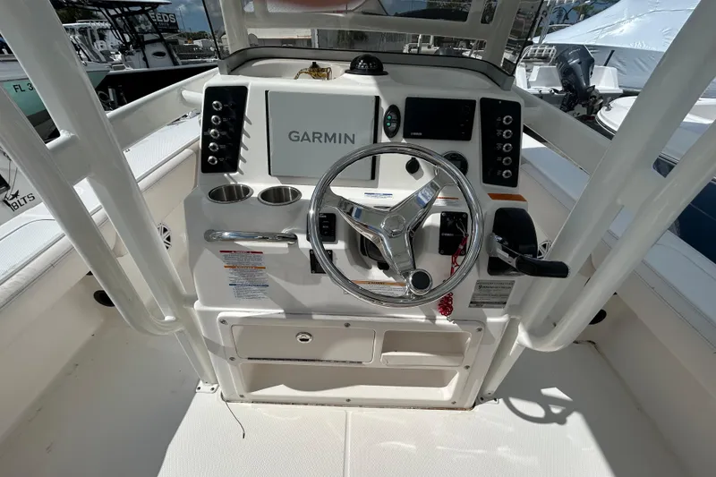 Slide: The Image of 2016 Robalo 246 Cayman boat console with Garmin navigation and steering wheel. - 10