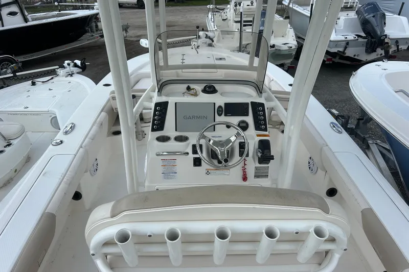 Slide: The Image of 2016 Robalo 246 Cayman boat cockpit with Garmin navigation system and steering wheel. - 13