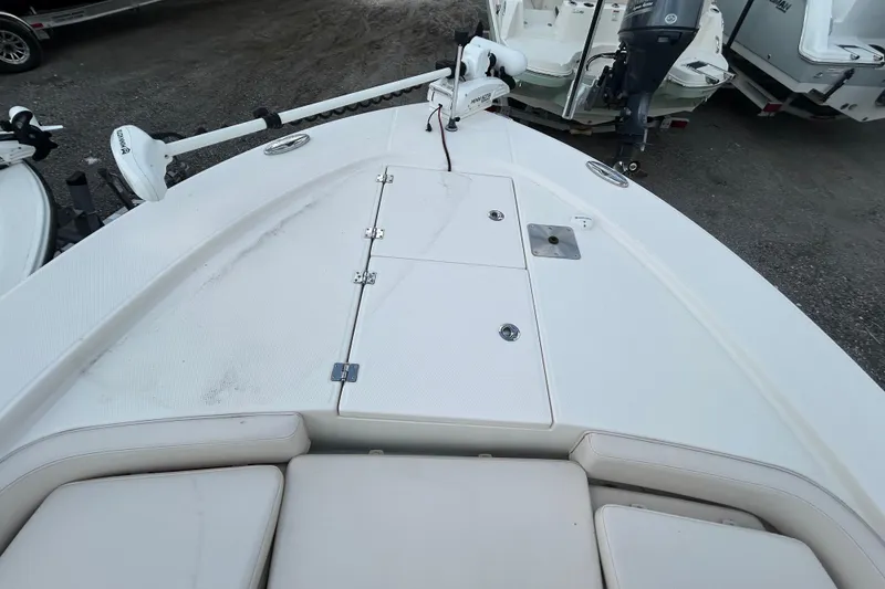 Slide: The Image of 2016 Robalo 246 Cayman boat deck with storage compartments and trolling motor. - 15