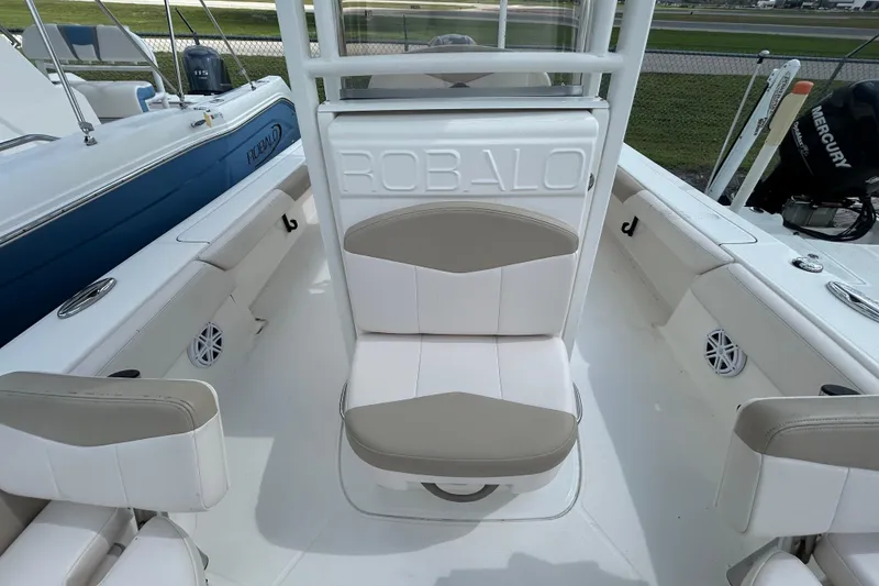 Slide: The Image of 2016 Robalo 246 Cayman boat interior with seating and Mercury engine. - 17