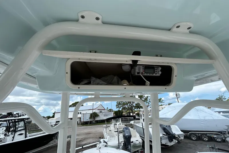Slide: The Image of 2016 Robalo 246 Cayman boat console with storage compartment and electronic equipment. - 19