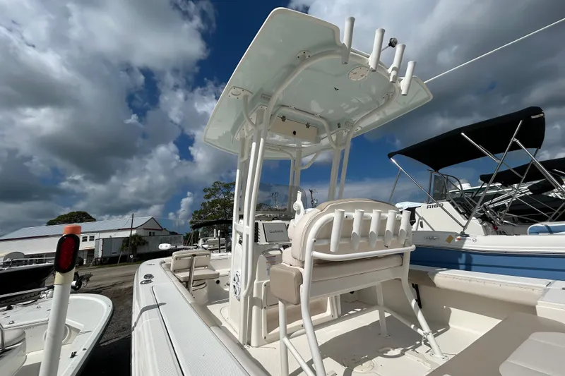 Slide: The Image of 2016 Robalo 246 Cayman boat with T-top and seating, under a cloudy sky. - 7