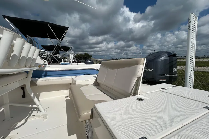 Slide: The Image of 2016 Robalo 246 Cayman boat interior with seating and Yamaha outboard motor. - 8