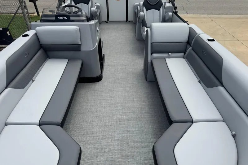 Slide: The Image of 2025 Veranda Vista Sport VS 22 RC pontoon boat interior with gray seating and steering console. - 4