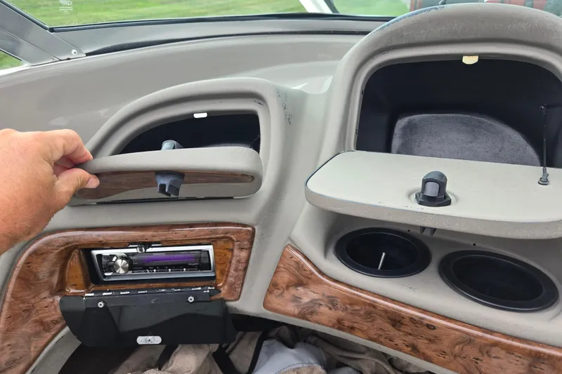 Slide: The Image of Dashboard of a 2001 Tahoe Q5S I/O boat with storage compartments and stereo system. - 14