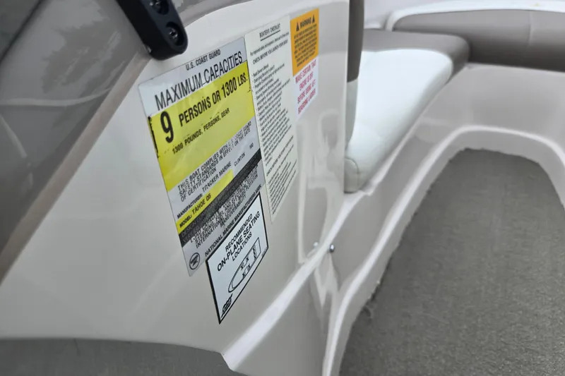 Slide: The Image of 2001 Tahoe Q5S I/O boat capacity label, seating for nine, maximum 1300 pounds. - 16