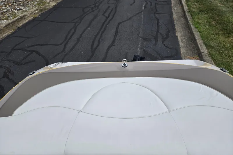 Slide: The Image of 2001 Tahoe Q5S I/O boat interior with white upholstery, parked on a paved road. - 22