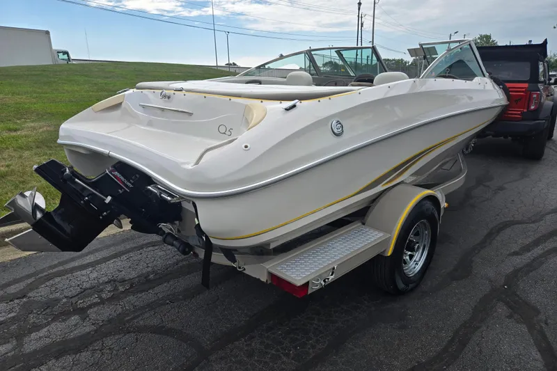 Slide: The Image of 2001 Tahoe Q5S I/O boat on trailer, parked outdoors. - 3