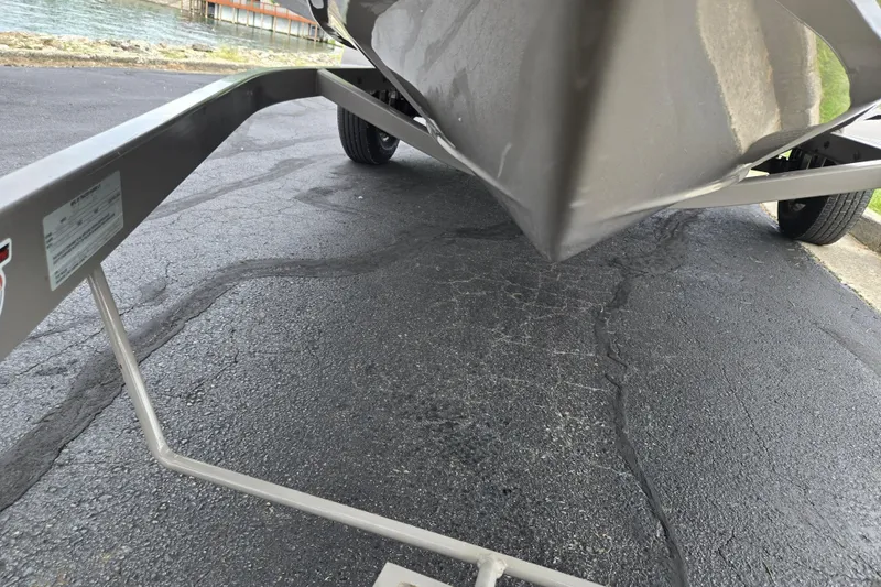 Slide: The Image of Boat trailer with Tahoe Q5S I/O, 2001 model, near waterfront on asphalt. - 7