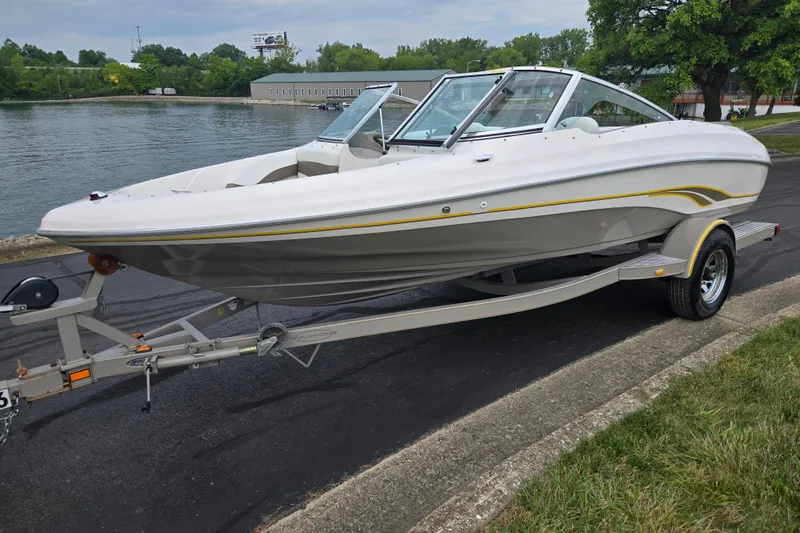 Slide: The Image of 2001 Tahoe Q5S I/O boat on trailer by a lakeside road. - 9