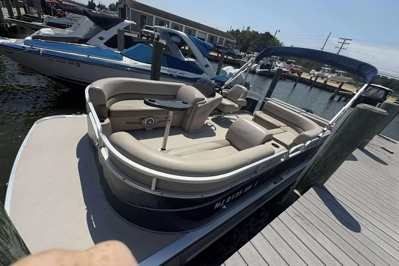 Slide: The Image of 2018 Avalon GS 2185 CR pontoon boat docked at marina, featuring spacious seating. - 10