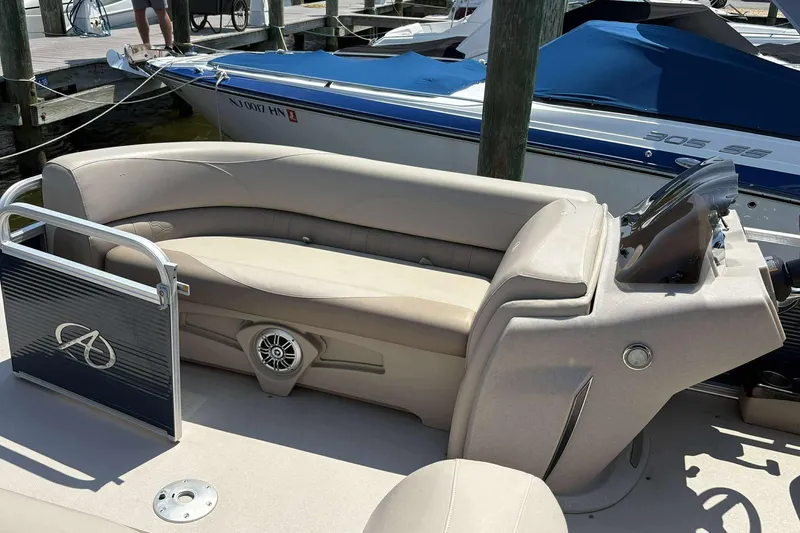 Slide: The Image of 2018 Avalon GS 2185 CR pontoon boat interior with beige seating at a dock. - 14