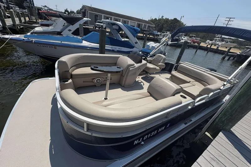 Slide: The Image of 2018 Avalon GS 2185 CR pontoon boat docked at marina, featuring spacious seating. - 2