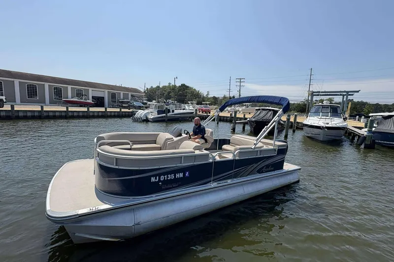Slide: The Image of 2018 Avalon GS 2185 CR pontoon boat docked at a marina on a sunny day. - 3
