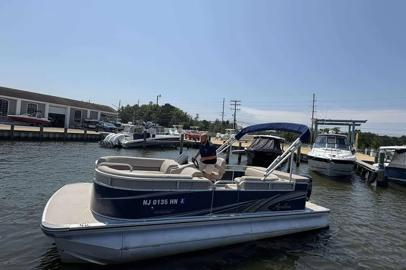 Slide: The Image of 2018 Avalon GS 2185 CR pontoon boat docked at a marina on a sunny day. - 4
