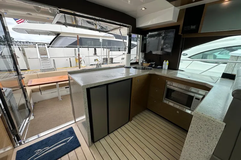 Slide: The Image of Luxurious 2013 Cruisers Yachts 45 Cantius interior with modern kitchen and outdoor seating area. - 12