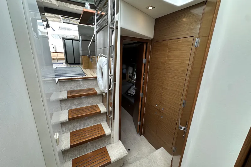Slide: The Image of Interior view of 2013 Cruisers Yachts 45 Cantius, featuring stairs and wooden cabinetry. - 29