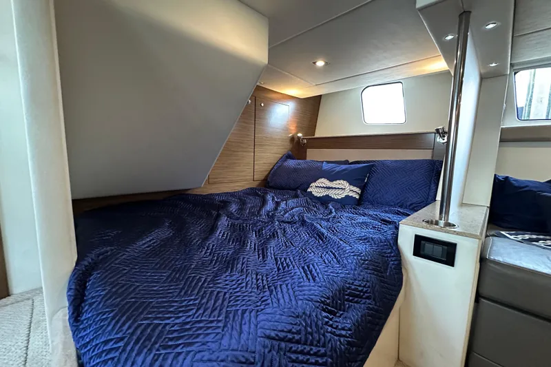 Slide: The Image of Luxurious cabin interior of 2013 Cruisers Yachts 45 Cantius with blue bedding. - 36