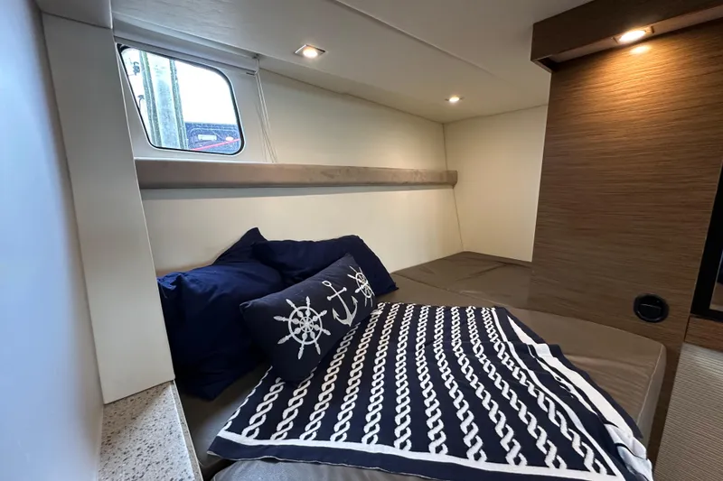 Slide: The Image of Luxurious cabin interior of 2013 Cruisers Yachts 45 Cantius with nautical-themed bedding. - 37